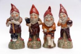 Collection of four pottery garden gnomes, decorated in typical fashion and colours, various