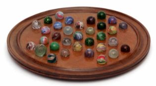 Collection of marbles with polychrome designs all on a wooden display base