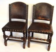 Set of six leather or rexine upholstered oak dining chairs with brass studs throughout