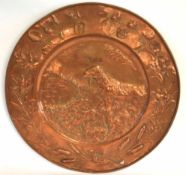 Circular large copper wall plaque decorated with foliage and dog retrieving a game bird, 56cms diam