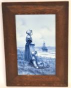 Two Dutch delft plaques in oak frames, signed by Verveer