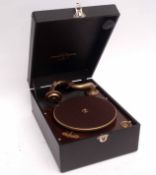 Mid-20th century cased Columbia portable turntable, the hinged black finished case with gilt