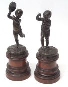 Pair of patinated bronze studies of musical putti on mahogany stands, 39 1/2cms high overall