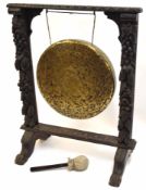 Late 19th century Gothic oak dinner gong, carved with fruit and foliage etc, central brass gong