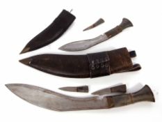 Mixed Lot: two various horn handled Kukris, each of typical form in leather bound scabbards, the