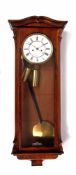 Late 19th century walnut cased twin weight driven Vienna type wall clock with shaped pediment,