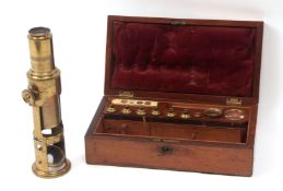 Mid-19th century rosewood cased lacquered brass drum microscope of typical form with screw adjusting