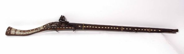 Middle Eastern flintlock camel gun, the flared barrel to a flintlock action and mounted with three