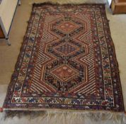 Late 20th century Caucasian carpet, three central lozenges, mainly black, beige and blue field