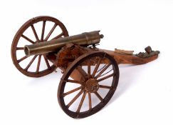 Scale model of field cannon of cast brass construction and mounted on a wooden carriage with steel