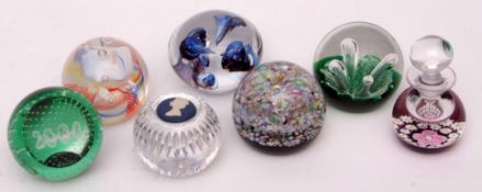 Collection of seven glass paperweights, some Perthshire paperweights, one with a Wedgwood inlay of