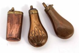 Mixed Lot: three various copper and brass powder flasks, two of baluster form, the third of