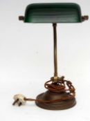 Desk lamp with solid green glass shade and brass fittings