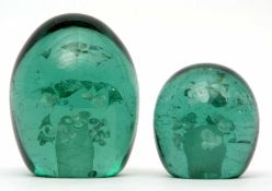 Two dump glass paperweights with typical designs, largest 12cms high