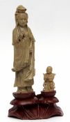 Soapstone model of an Oriental deity, probably Guanyin, alongside an acolyte paying homage, the