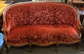 Mahogany sofa with arched back over a break front frieze and raised on moulded cabriole supports,