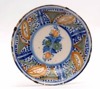 Dutch Delft dish with polychrome design of flowers interspersed with blue borders