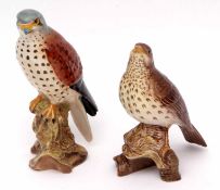 Group of two Beswick bird models, one of a Thrush and an Eaglet, both on rocky mound bases,