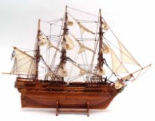 Carved model of a three-masted Man-o-war on stand, 82cms long