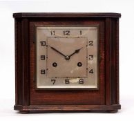 Mid-20th century oak cased mantel clock, the plinth shaped case to a square bezel enclosing a