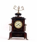 Late 19th century French black and variegated rouge marble mounted mantel clock, the plinth shaped