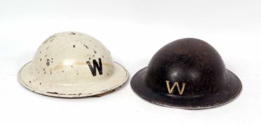 Mixed Lot: two various British steel helmets, painted one each white and black and both initialled