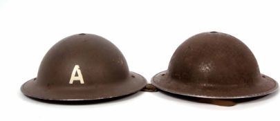 Mixed Lot: two British steel helmets, the first painted A, the second plain and stamped 1939,