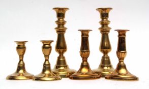 Group of three sets of brass candlesticks