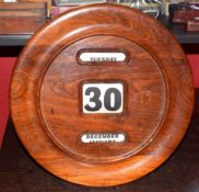 Early 20th century walnut cased and wall mounted calendar, the moulded surround to a pierced dial