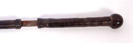 20th century tribal sword, the plain blade (heavily rusted) to a bound leather handle and further