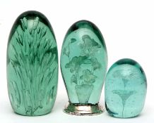 Collection of three dump glass green ground paperweights, largest 16cms