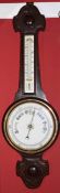 Early 20th century carved oak aneroid barometer with twin scale porcelain backed mercury thermometer