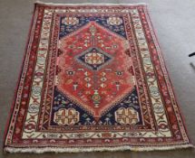 Late 20th century Caucasian rug, central geometric lozenge, mainly red and dark blue field with