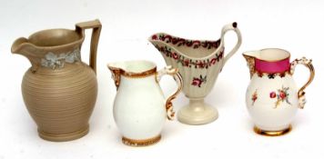 Group of four porcelain jugs, one with a mask spout and mask to handle, the second in similar