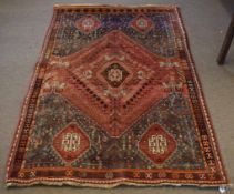 20th century Caucasian wool carpet, single central lozenge with four further lozenges to corners,