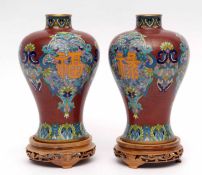 Pair of modern cloisonne baluster vases on wooden bases with typical enamelled decoration, 32cms