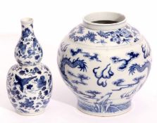 19th century Chinese bulbous vase decorated in underglaze blue with a sinuous dragon chasing the