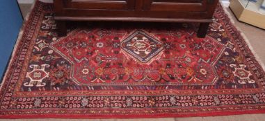 Late 20th century Qashqai carpet, single central lozenge, multi-gull border, mainly red, blue and