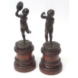 Pair of patinated bronze studies of musical putti on mahogany stands, 39 1/2 cms high overall