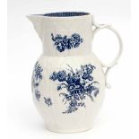 18th century Caughley cabbage leaf mask jug painted in underglaze blue with floral sprays, 23cm high