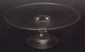 18th century glass tazza of plain circular form with slight raised rim on a short balustered