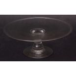 18th century glass tazza of plain circular form with slight raised rim on a short balustered