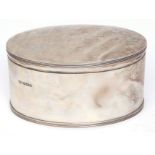 George V oval canister of plain and polished form with initialled cover and reeded rims, width 17cm,