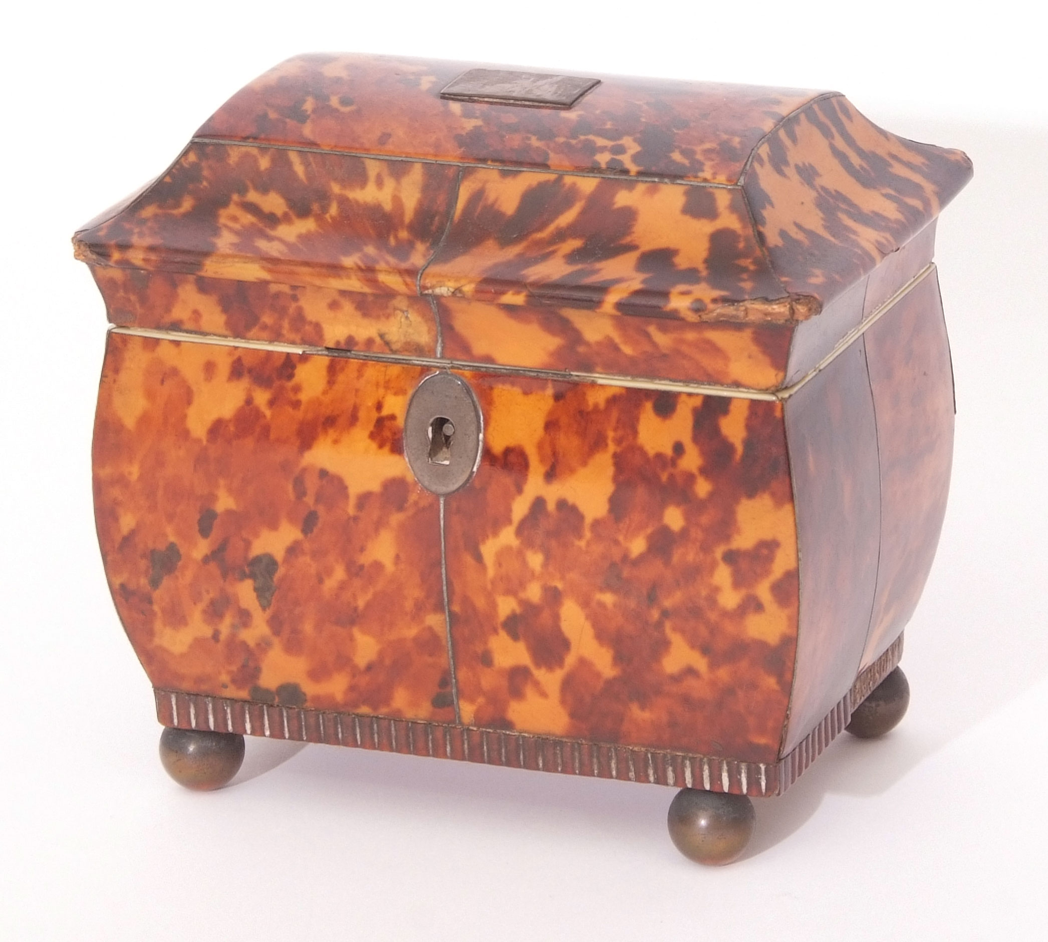 Early 19th century tortoiseshell tea caddy of sarcophagus form, the lifting lid enclosing an