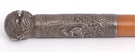 Early 20th century Far Eastern white metal mounted malacca walking cane, the white metal handle