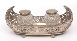 George V ink stand of oval form with pierced gallery and rope twist border raised on compressed