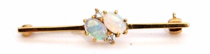 18ct gold, opal and diamond bar brooch featuring two oval cut opals flanked by two small brilliant