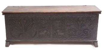 18th century stained pine cassone, plain plank top over elaborately carved panelled front, decorated