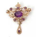 Antique openwork amethyst and seed pearl brooch having a centrally set oval amethyst, the foliate