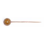 Antique diamond and seed pearl set stick pin, circular disc shaped finial with a central old cut